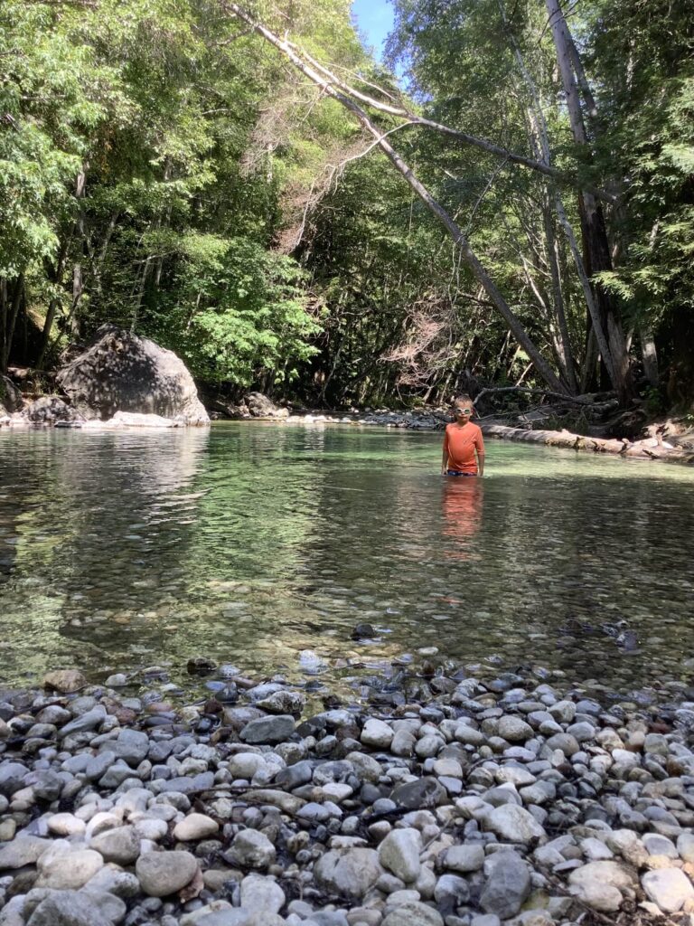 Boy standing in Big Sur River